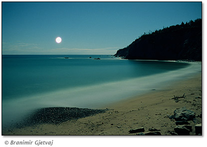 Image of moonrise over Broad Cove, Cape Breton Island, Nova Scotia, Canada