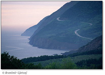 Image of a car on Cabot Trail at sunset, Cape Breton Highlands National Park, Nova Scotia