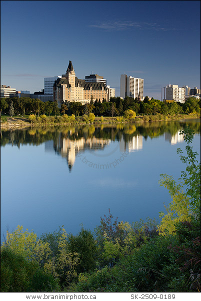 Saskatoon city skyline with Delta Bessborough hotel reflecting in South Saskatchewan river