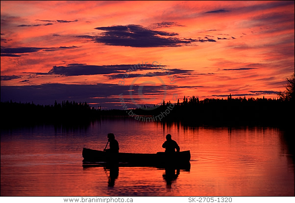 Silhouette of a couple canoeing at sunset, Saskatchewan