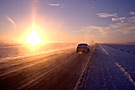 car driving through snow storm at sunrise, Saskatchewan Landing Prov. Park